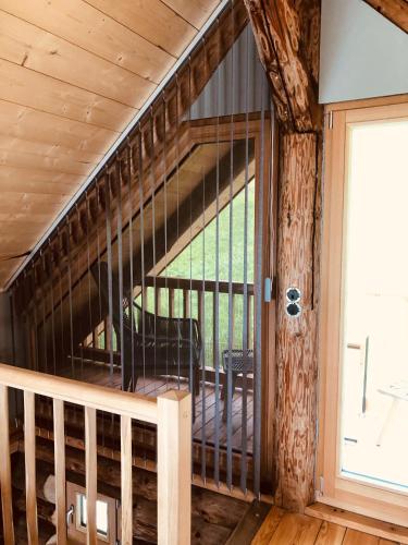 a spiral staircase in a log cabin with a window at Blockhaus PanHütte in Braunlage
