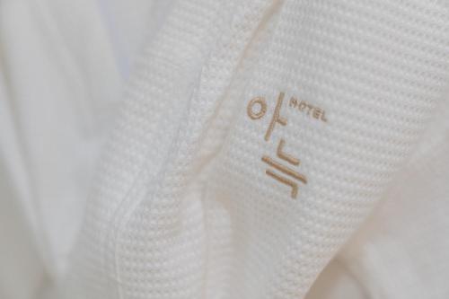 a close up of a white shirt with the word otto on it at Aank Hotel Cheonan Station 2nd in Cheonan