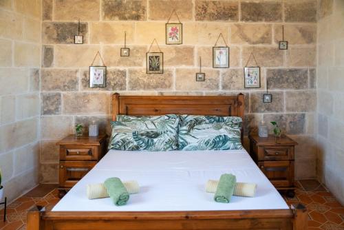 a bedroom with a bed with two pillows on it at Laremi Gozo B&B in Nadur