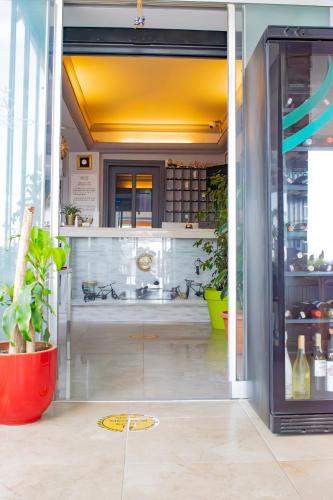 a glass door leading into a kitchen with plants at Akkan Beach Hotel in Bodrum City