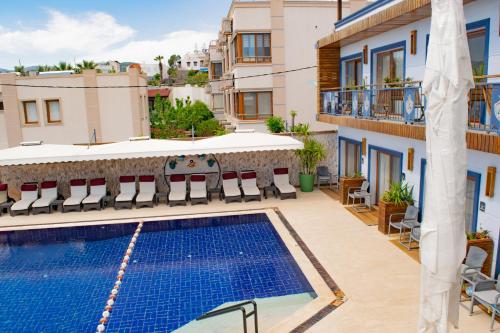 a view of a swimming pool on a building at Akkan Beach Hotel in Bodrum City