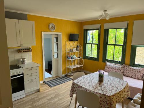 a kitchen and dining room with a table and chairs at Theothea Suites in Kavála