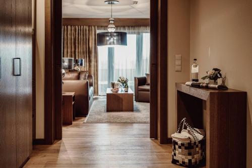 a hallway with a living room with a fireplace at Der Eisvogel - Wellness- & Genusshotel in Bad Gögging