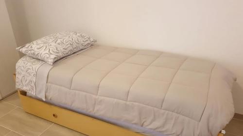een klein bed in een kamer met een matras bij Attico con terrazzo Relax in Ladispoli