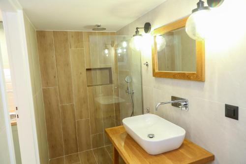 a bathroom with a sink and a shower at Heaven Apartments in Agia Marina Nea Kydonias