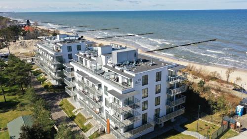 an aerial view of a building next to the beach at Jantaris, Sun & Snow in Mielno