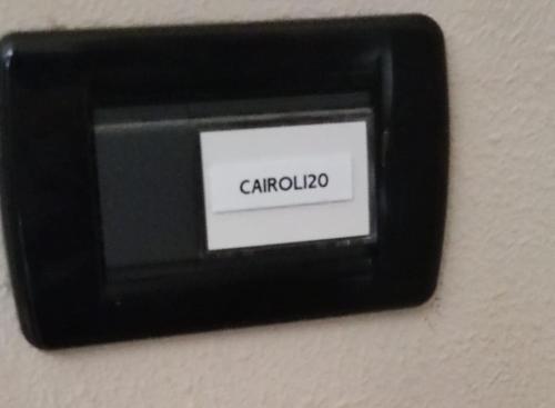 a black lightswitch on a wall with the word carphone at Cairoli20 in Vicenza