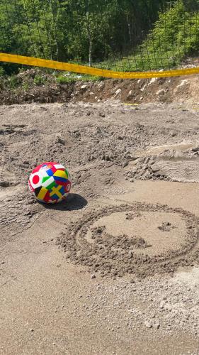 a soccer ball in the sand next to a heart in the sand at Josanica Bed&Breakfast in Konjic