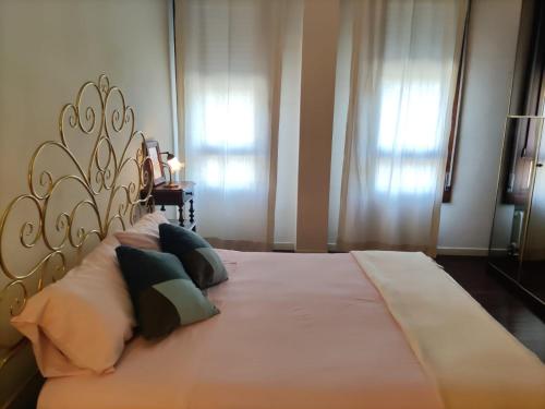 a bedroom with a large bed with pillows on it at Cairoli20 in Vicenza