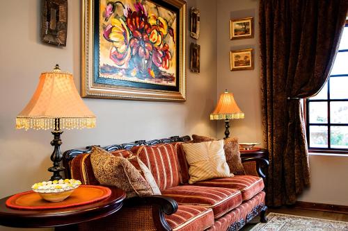 a living room with a couch and two lamps at aHa Guest House in Sea View