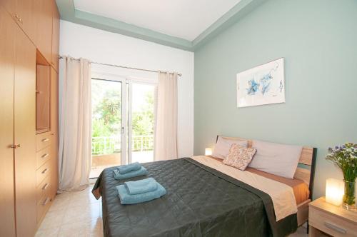 a bedroom with a bed with blue towels on it at Vicinia Guest House in Rhodes Town