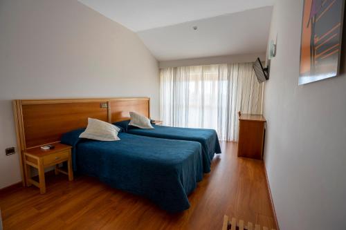 Ένα ή περισσότερα κρεβάτια σε δωμάτιο στο Los Barruecos - BGA HOTELES