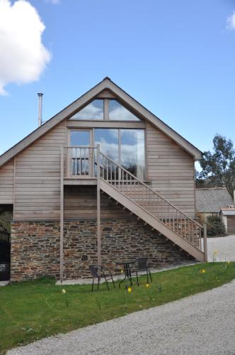 a house with a staircase on the side of it at Fernsplatt Farm Lodge in Truro