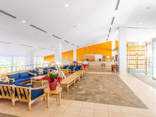 a large room with blue couches and a lobby at Nichinankaigan Nango Prince Hotel in Nichinan