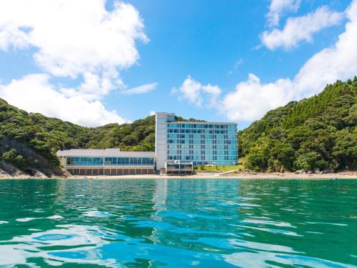 a view of a building from the water at Nichinankaigan Nango Prince Hotel in Nichinan