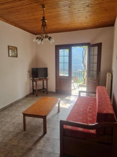 a living room with a couch and a table at Zeus Apartman in Panagia