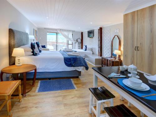 a bedroom with a large bed and a desk with a table at RiverView in Wilderness