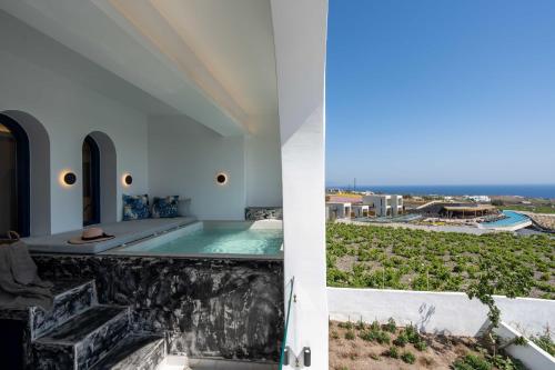 a view of a swimming pool from a house at Amera Suites in Fira