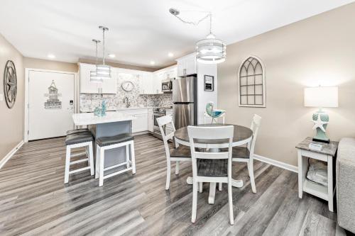 a kitchen and dining room with a table and chairs at Plantation 2308 in Gulf Shores