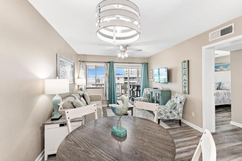 a living room with a table and a couch at Plantation 2308 in Gulf Shores