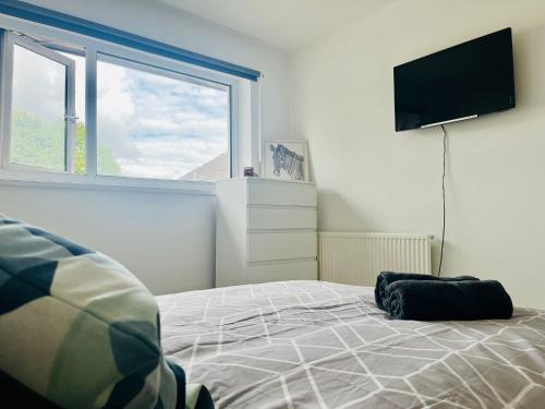 a bedroom with a bed and a flat screen tv at BEA Allenby Walk in Manchester