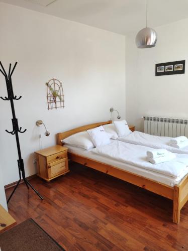 a bedroom with a bed with white sheets and a lamp at Rezydencja Bukowy Dwór in Czarna