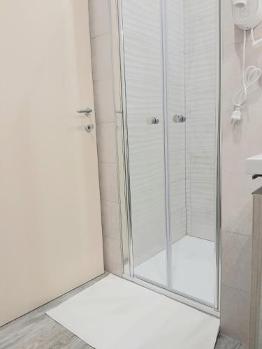 a shower with a glass door in a bathroom at Dimora Pié del Castello in Conversano