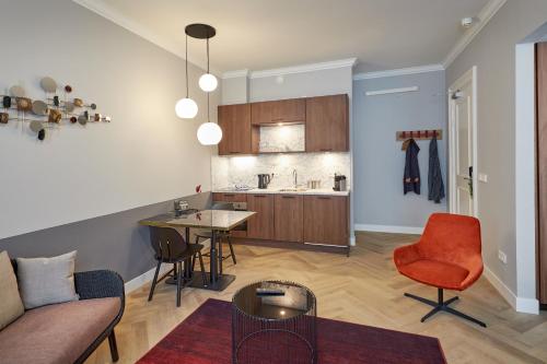 a kitchen and living room with a couch and a table at Nova Apartments Amsterdam in Amsterdam