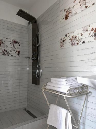 a shower in a bathroom with a glass shower stall at A SZELLŐ in Domonyvölgy