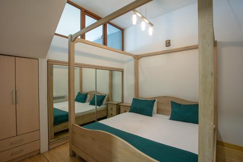 a bedroom with two beds and a mirror at Luxe Apartment in Center in Yerevan