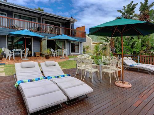 a deck with a table and chairs and an umbrella at RiverView in Wilderness