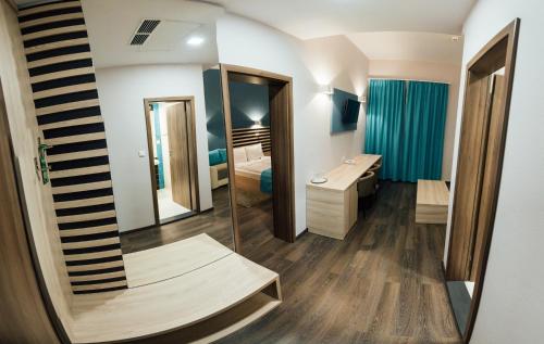 a bathroom with a sink and a mirror at Altus Hotel & Spa in Praid