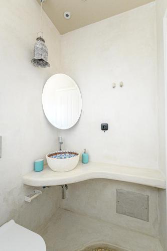 a bathroom with a sink and a mirror at Ios Resort in Ios Chora