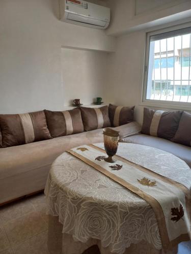 a living room with a couch and a table at STAR APPARTEMENT GAUTHIER in Casablanca