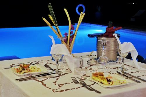 a table with plates of food on a table at Le Grand Bleu in Andilana