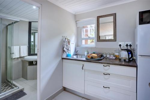 a white bathroom with a sink and a shower at RiverView in Wilderness