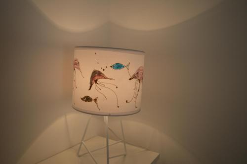 a fish bowl with a painting of fishes on it at Summer House Krištof in Vrbanj