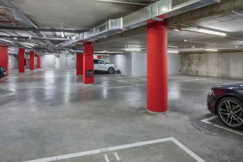 a parking lot with red columns and a car parked in it at B&B HOTEL Zaragoza Plaza Mozart in Zaragoza