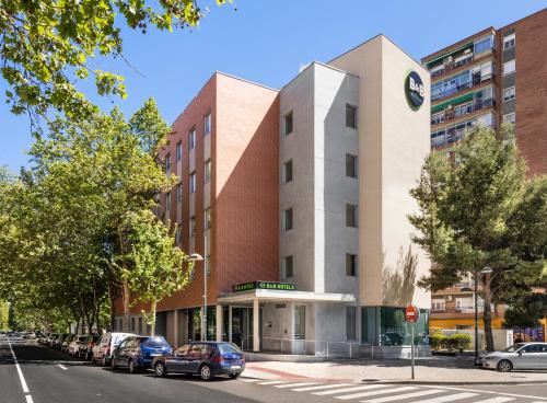 a building with cars parked in front of it at B&B HOTEL Zaragoza Plaza Mozart in Zaragoza