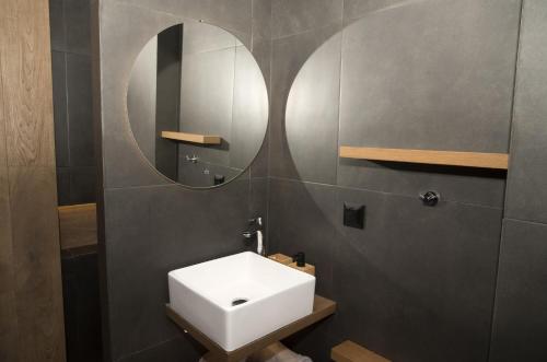 a bathroom with a white sink and a mirror at Friends Luxury Apartment In Marousi in Athens