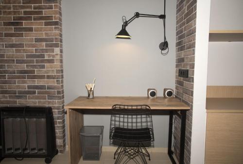 a desk in a room with a brick wall at Friends Luxury Apartment In Marousi in Athens
