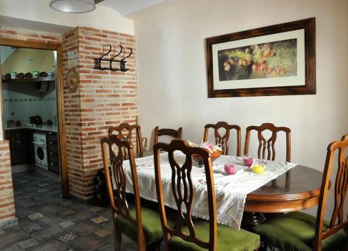 a dining room with a table and eight chairs at Casa en Blanca Murcia, en el centro. C/ Teatro, 5 in Blanca