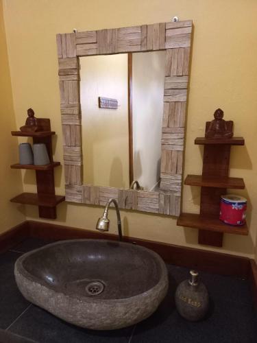 a bathroom with a sink and a mirror at Werkudara Guest House in Ubud