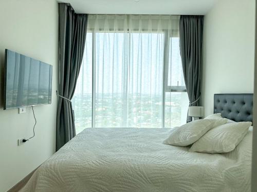 a bedroom with a bed and a large window at The Riviera Jomtien Brand new 1 Bedroom in Jomtien Beach