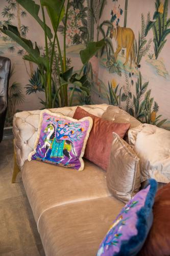 a couch with pillows on it in a living room at Niss Lara Hotel in Antalya