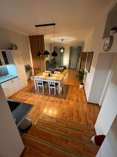 a kitchen and living room with a table and chairs at Villa Monica in Kráľovský Chlmec