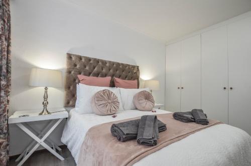 a bedroom with a large bed with two towels on it at Wees Gerus in Yzerfontein
