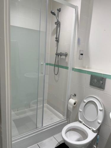 a bathroom with a shower and a toilet at Double Bedroom with Ensuite in Ilford