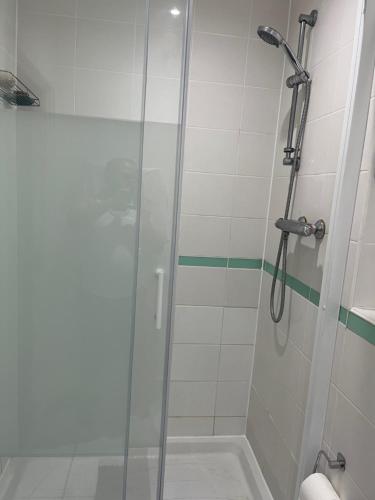 a shower with a glass door in a bathroom at Double Bedroom with Ensuite in Ilford