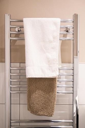 a towel hanging on a towel rack in a bathroom at Velvet 2-bedroom apartment, Conduit Lane, Hoddesdon in Hoddesdon